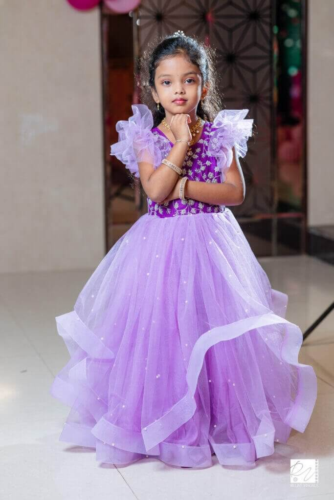 Smiling birthday girl Young girl in birthday attire striking a cheerful pose