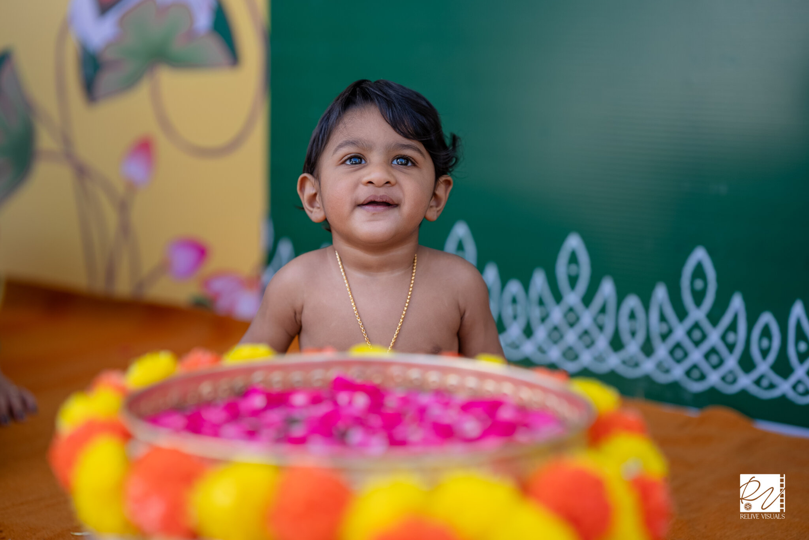 Birthday boy playing joyfully near a flower-filled pond